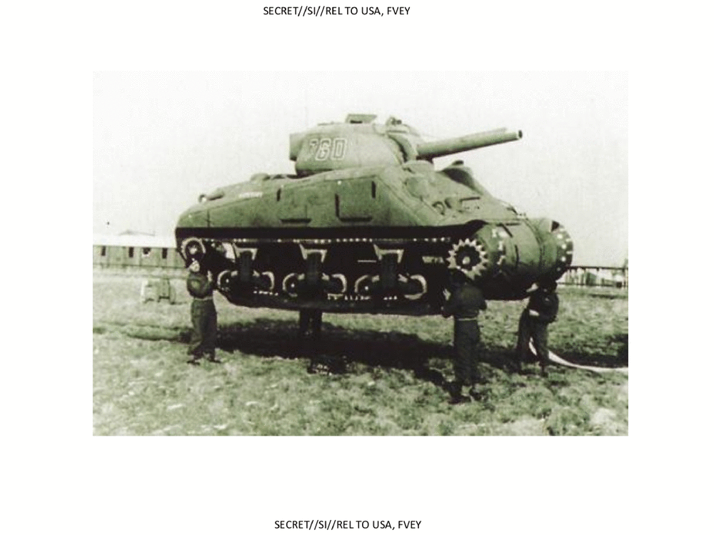 four men lifting a tank